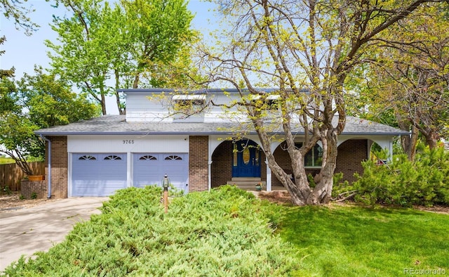 9765 W 77th Dr, Arvada, CO 80005 - traditional-style house featuring brick siding, driveway, covered porch, and a garage