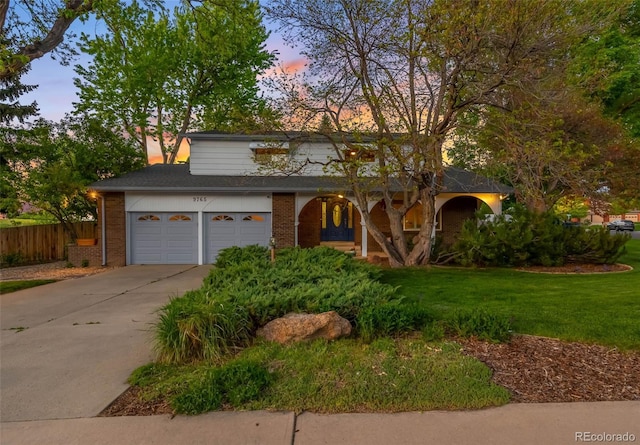 9765 W 77th Dr, Arvada, CO 80005 - traditional-style home with concrete driveway, brick siding, and covered porch