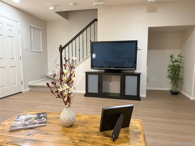 10676 Forester Pl, Longmont, CO 80504 - living room with wood finished floors, baseboards, and stairway