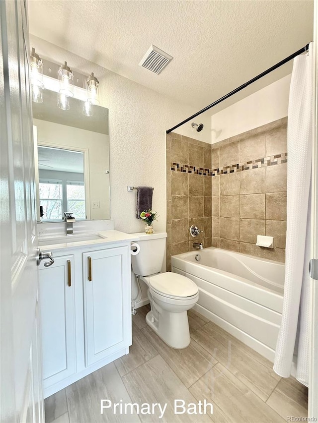 10676 Forester Pl, Longmont, CO 80504 - bathroom with shower / bath combo with shower curtain, toilet, vanity, a textured ceiling, and wood finished floors