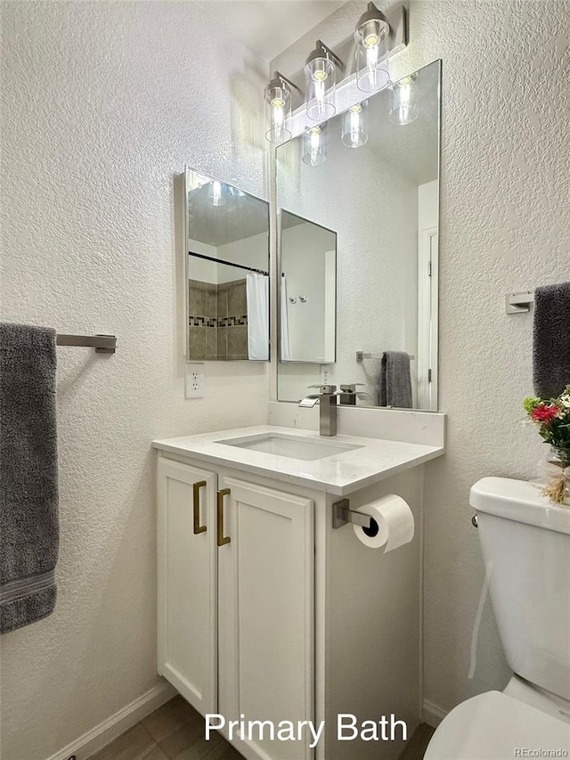 10676 Forester Pl, Longmont, CO 80504 - bathroom featuring vanity, toilet, a textured wall, and a shower with curtain