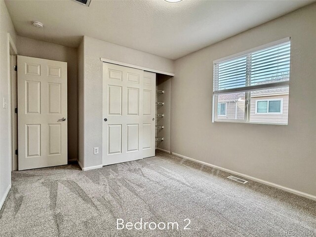 10676 Forester Pl, Longmont, CO 80504 - unfurnished bedroom with carpet flooring, baseboards, and a closet
