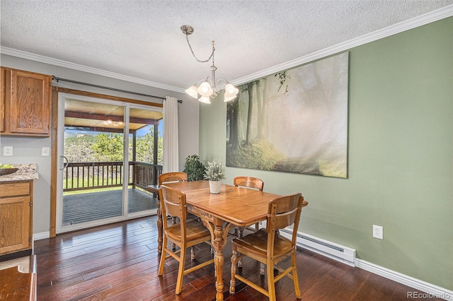 19260 Spring Valley Rd, Monument, CO 80132 - dining area featuring baseboard heating, crown molding, a textured ceiling, baseboards, and dark wood finished floors