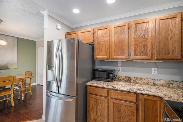 19260 Spring Valley Rd, Monument, CO 80132 - kitchen with stainless steel fridge with ice dispenser, black microwave, ornamental molding, dark wood finished floors, and brown cabinets