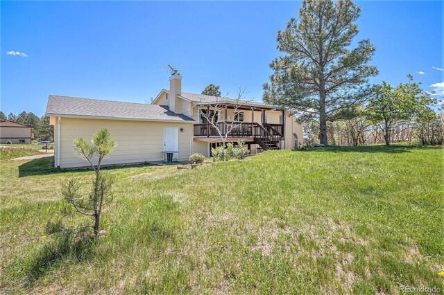 19260 Spring Valley Rd, Monument, CO 80132 - back of house with a wooden deck, a chimney, a yard, and stairway