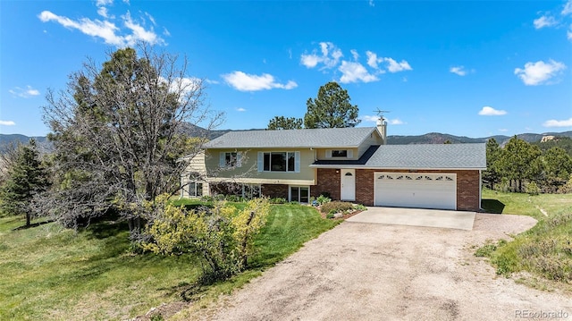 19260 Spring Valley Rd, Monument, CO 80132 - view of front facade featuring concrete driveway, brick siding, an attached garage, and a front lawn