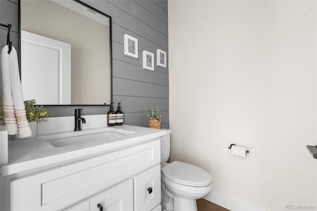 1305 Osceola St, Denver, CO 80204 - bathroom featuring vanity, toilet, baseboards, and wood finished floors