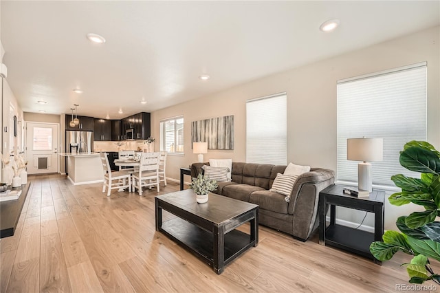 12770 Tamarac St, Thornton, CO 80602 - living room with light wood-style floors, recessed lighting, and baseboards