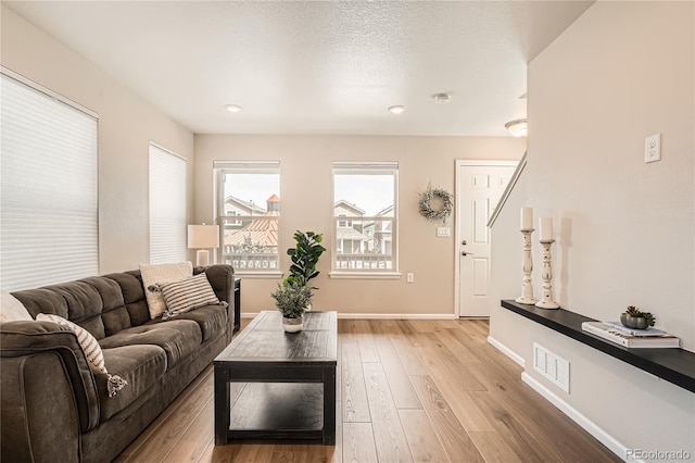 12770 Tamarac St, Thornton, CO 80602 - living area featuring recessed lighting, baseboards, visible vents, and light wood-style floors