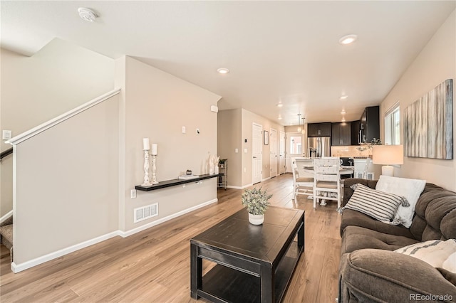 12770 Tamarac St, Thornton, CO 80602 - living area with visible vents, recessed lighting, light wood-style floors, and baseboards