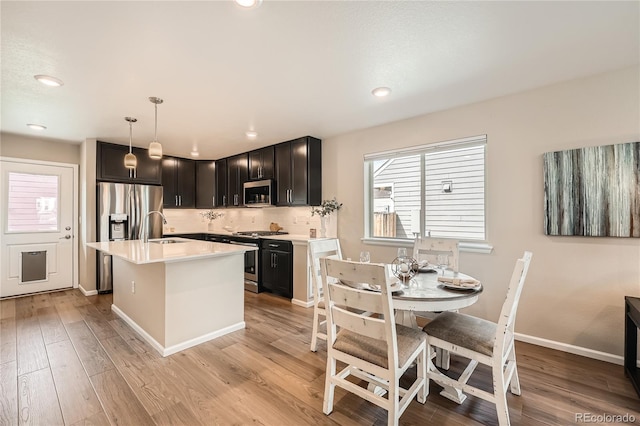 12770 Tamarac St, Thornton, CO 80602 - kitchen featuring light countertops, stainless steel appliances, a sink, and light wood-style floors