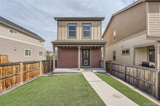 12770 Tamarac St, Thornton, CO 80602 - rear view of property featuring board and batten siding, a fenced backyard, and covered porch