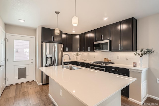 12770 Tamarac St, Thornton, CO 80602 - kitchen featuring stainless steel appliances, light wood-style flooring, decorative backsplash, and recessed lighting