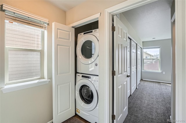 12770 Tamarac St, Thornton, CO 80602 - laundry room featuring stacked washing machine and dryer and dark colored carpet