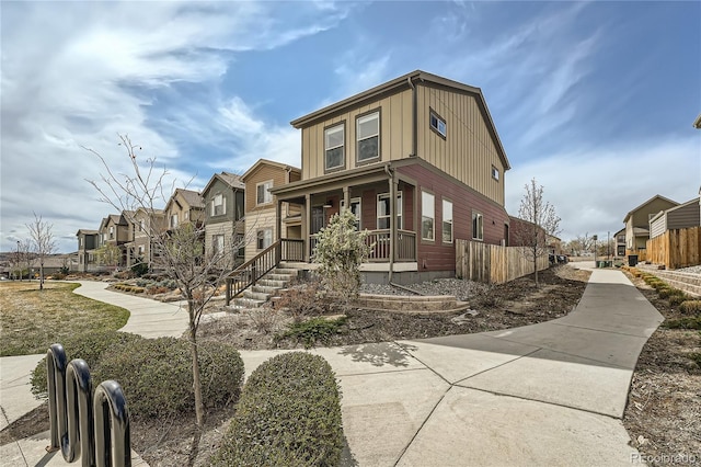 12770 Tamarac St, Thornton, CO 80602 - view of front of house with board and batten siding, a residential view, and covered porch