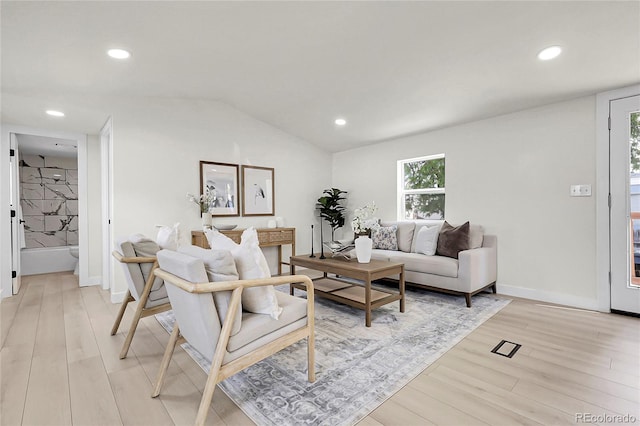 8497 Madison Way, Denver, CO 80229 - living area featuring light wood finished floors, recessed lighting, baseboards, and lofted ceiling