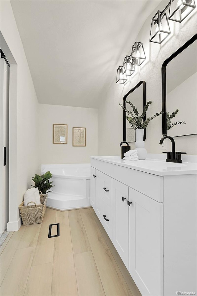 8497 Madison Way, Denver, CO 80229 - full bathroom featuring double vanity and a garden tub