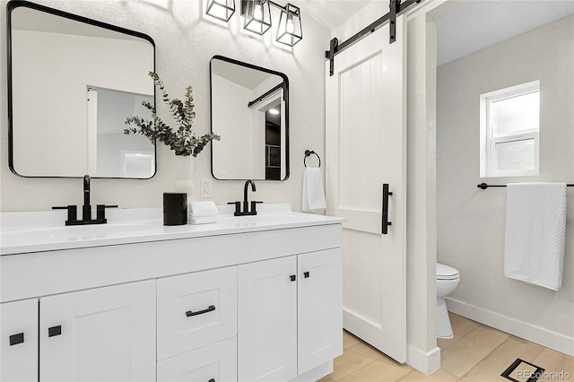 8497 Madison Way, Denver, CO 80229 - full bathroom with double vanity, toilet, baseboards, and tile patterned floors