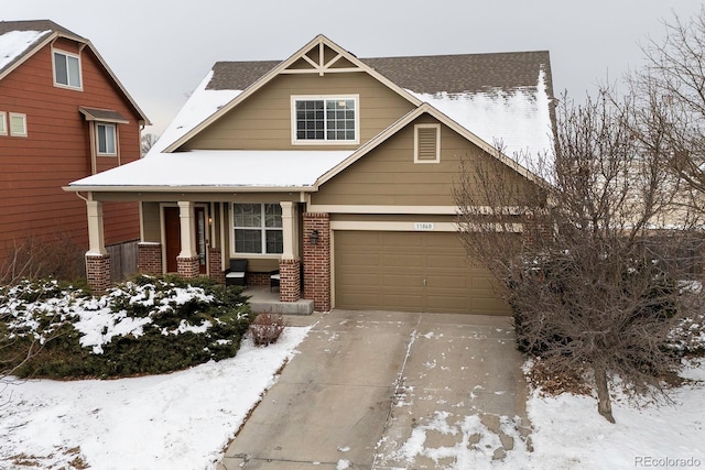 view of front facade featuring a porch, concrete driveway, brick siding, and a garage