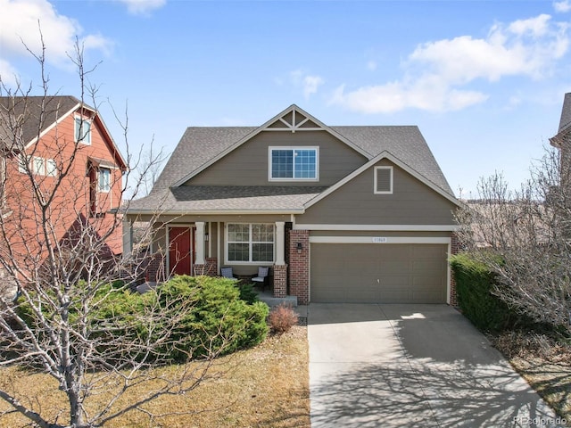 view of front of house with brick siding, driveway, and a shingled roof