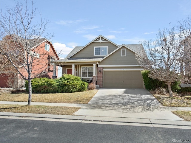 craftsman house with brick siding and driveway