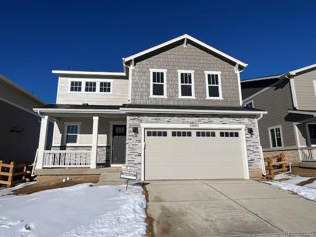 view of front of home featuring a porch and a garage