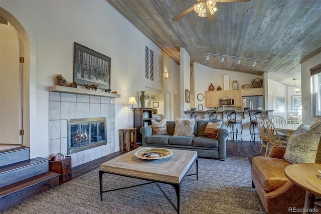 965 Four Oclock Rd, Breckenridge, CO 80424 - living room featuring wooden ceiling, wood finished floors, a ceiling fan, a tiled fireplace, and high vaulted ceiling