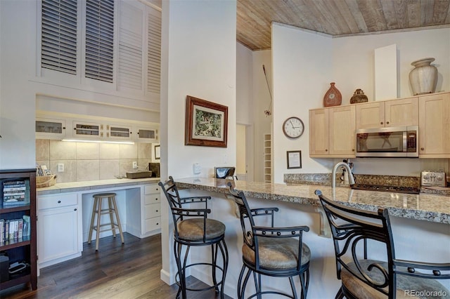 965 Four Oclock Rd, Breckenridge, CO 80424 - kitchen featuring stainless steel microwave, a kitchen bar, dark wood-type flooring, and wooden ceiling