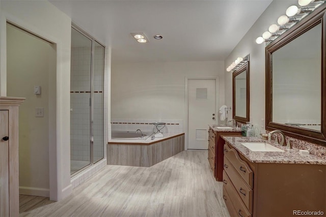 965 Four Oclock Rd, Breckenridge, CO 80424 - full bathroom with wood finished floors, two vanities, a bath, and a stall shower