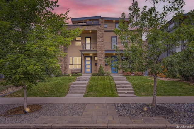 4170 Vrain St, Denver, CO 80212 - view of front of house with a balcony, stone siding, a lawn, and stucco siding