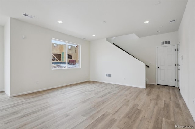 unfurnished living room with light wood-style floors, recessed lighting, and visible vents