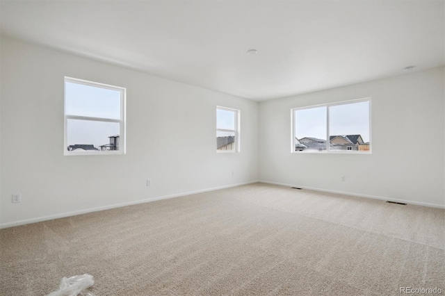 carpeted spare room with baseboards