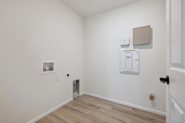 laundry area with laundry area, baseboards, light wood-style floors, and hookup for an electric dryer