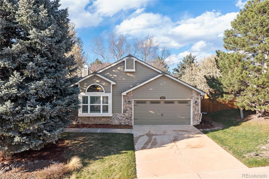 21593 Hill Gail Way, Parker, CO 80138 - view of front of house with an attached garage, fence, stone siding, and driveway