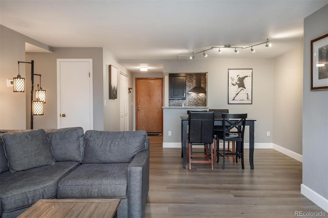 living area featuring wood finished floors and baseboards