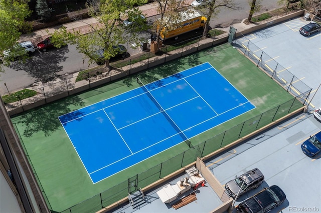 view of tennis court featuring fence