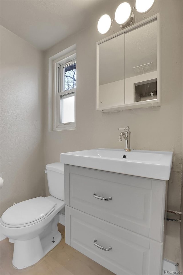 half bath with vanity and toilet