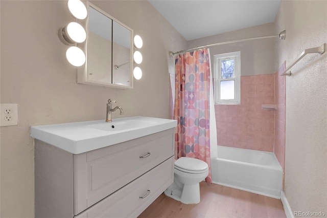 bathroom with toilet, shower / tub combo, wood finished floors, and vanity