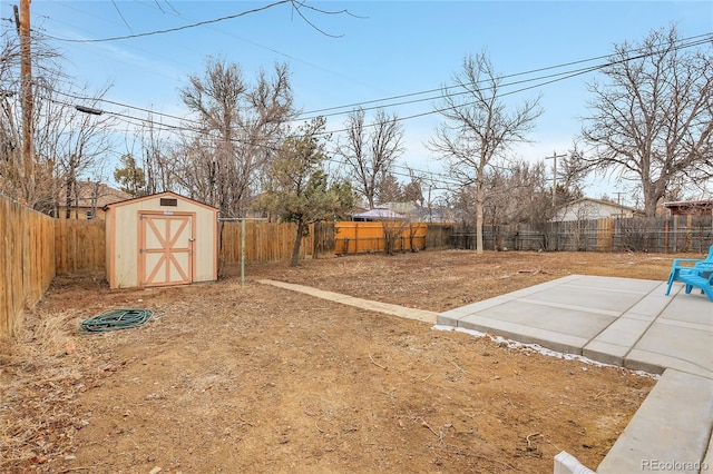 view of yard featuring a fenced backyard, an outdoor structure, a patio, and a storage unit