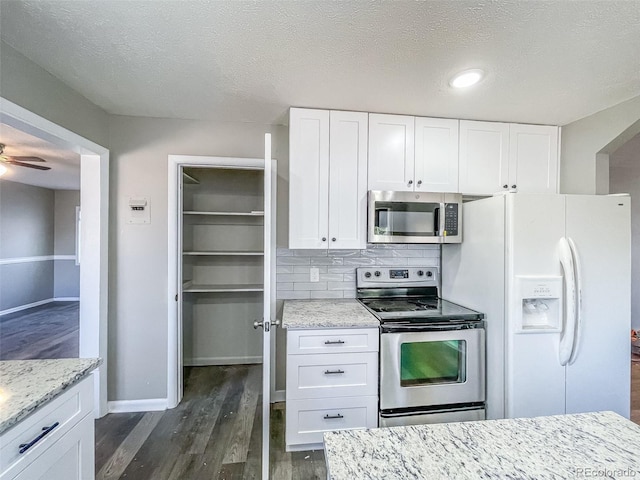 kitchen featuring white cabinetry, stainless steel appliances, and a textured ceiling