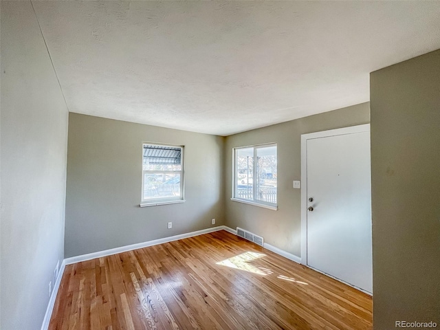 unfurnished room featuring hardwood / wood-style floors