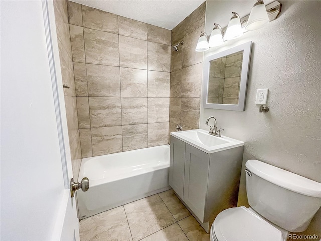 full bathroom featuring tile patterned flooring, vanity, a textured ceiling, tiled shower / bath, and toilet