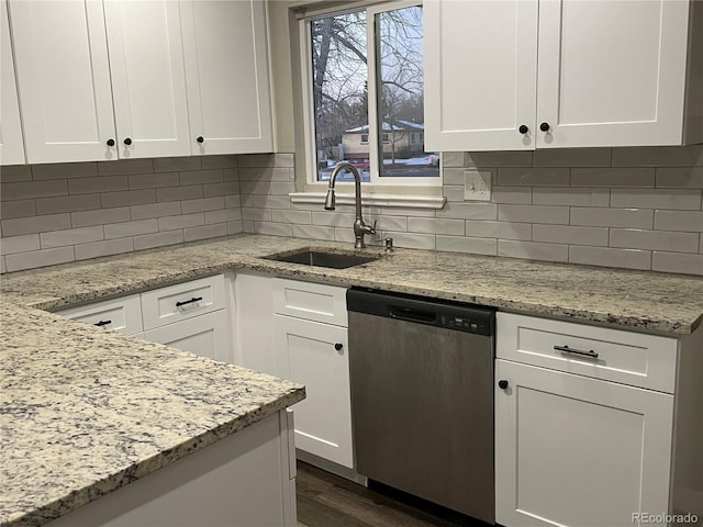 kitchen with sink, dishwasher, light stone countertops, decorative backsplash, and white cabinets