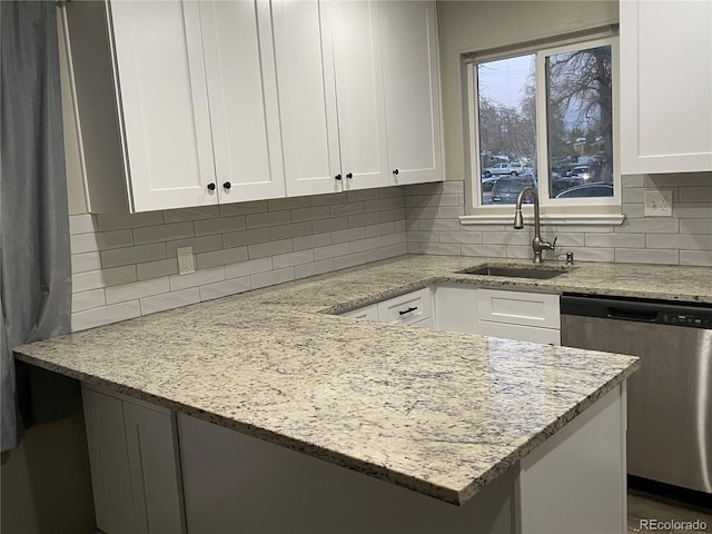 kitchen with white cabinetry, sink, and stainless steel dishwasher