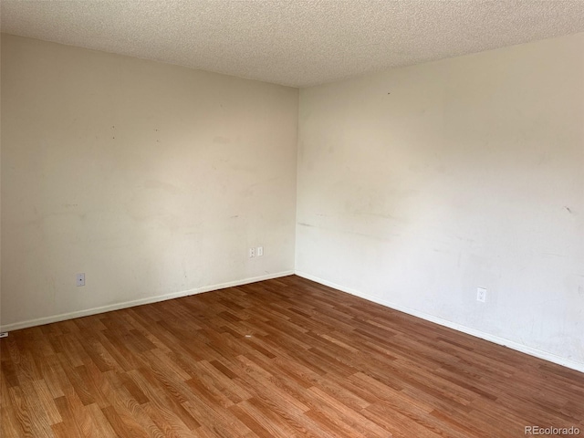 2513 S Crystal St, Aurora, CO 80014 - spare room featuring wood finished floors and a textured ceiling