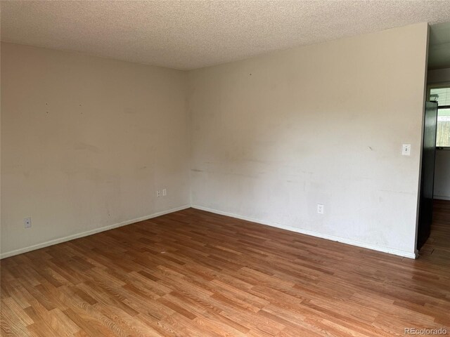 2513 S Crystal St, Aurora, CO 80014 - empty room with light wood-type flooring and a textured ceiling