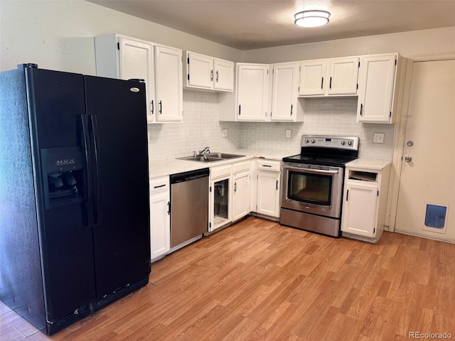 2513 S Crystal St, Aurora, CO 80014 - kitchen with stainless steel appliances, light countertops, white cabinetry, light wood-style floors, and backsplash