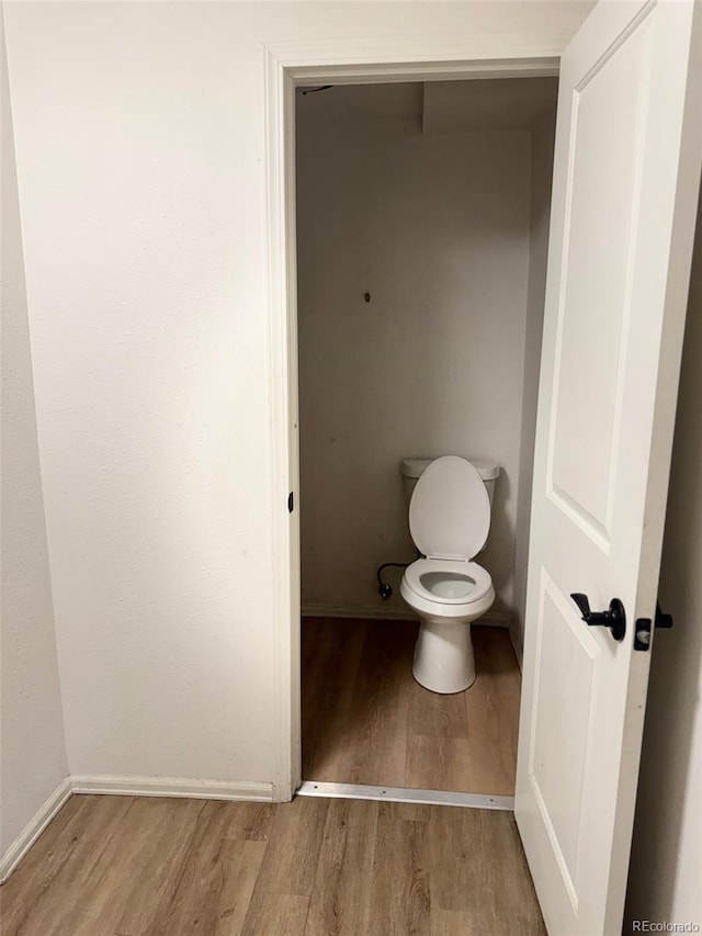 2513 S Crystal St, Aurora, CO 80014 - bathroom featuring wood finished floors and toilet