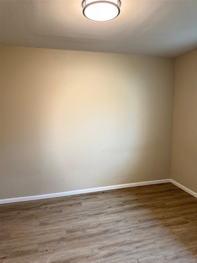 2513 S Crystal St, Aurora, CO 80014 - empty room with wood finished floors and baseboards