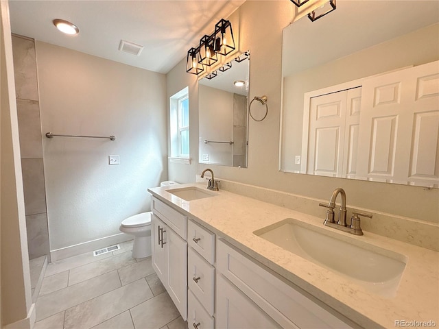 bathroom featuring vanity, toilet, and tile patterned floors